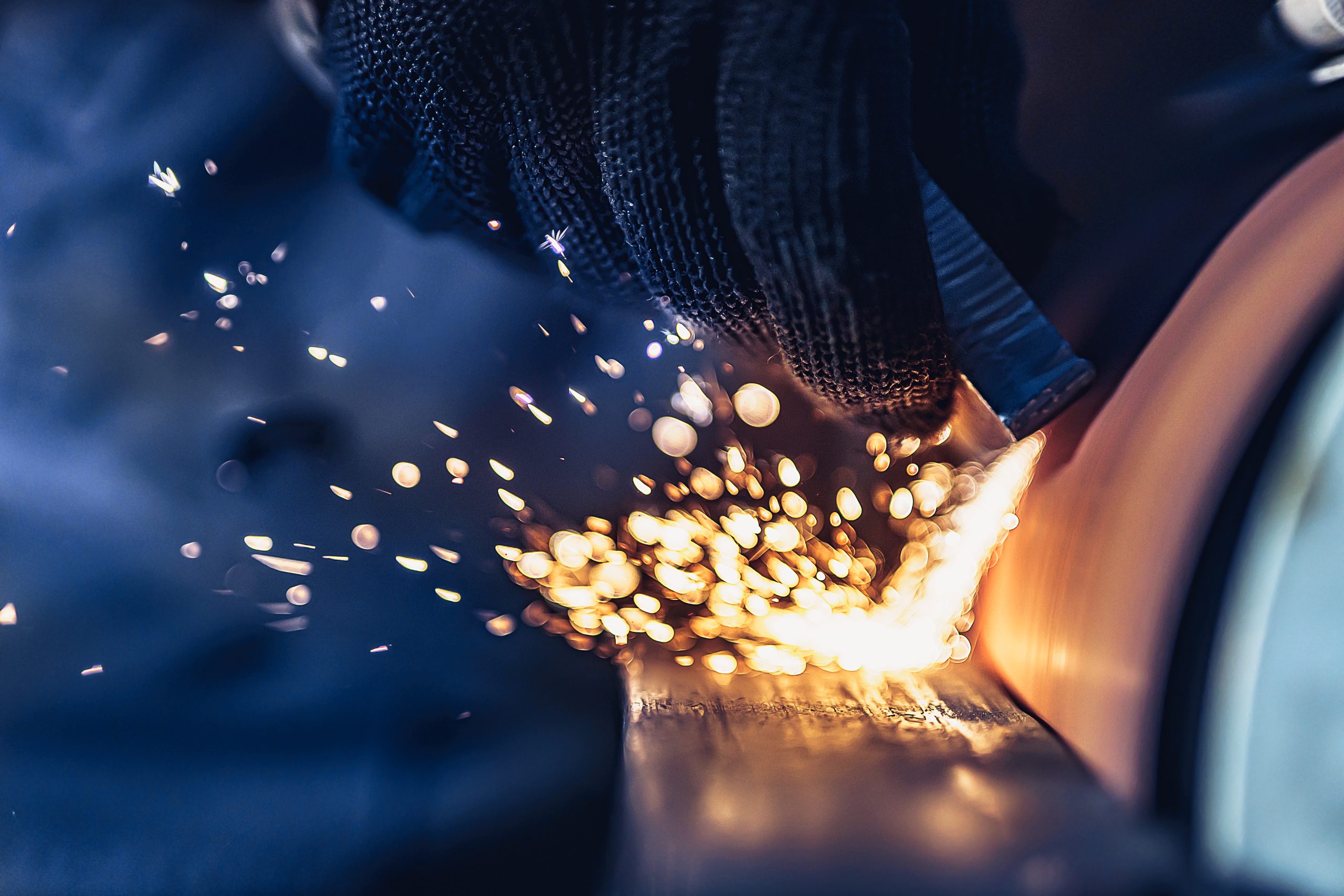 Closeup of Sparks that fly out when grinding metal details machine. Metallurgical Plant
