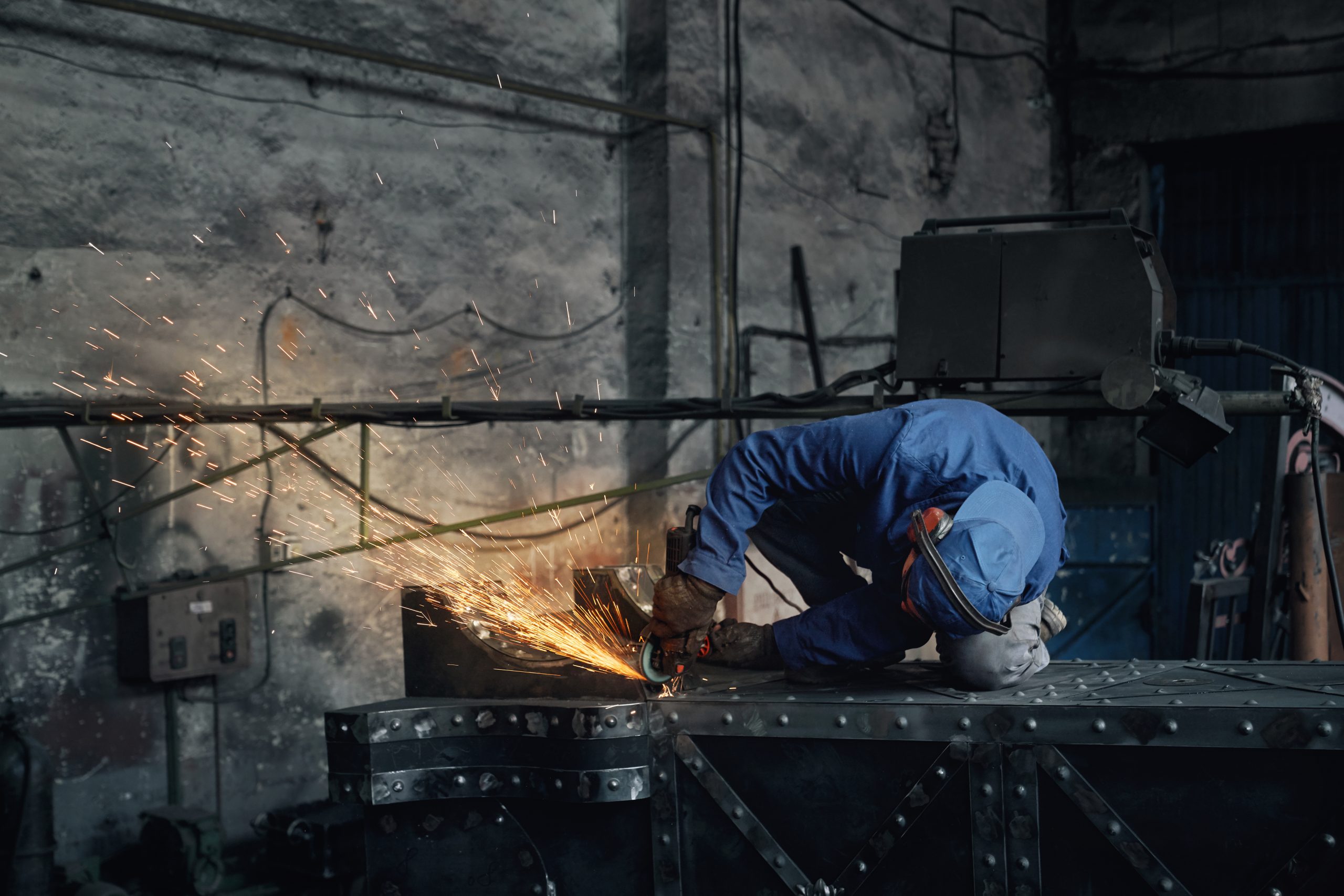 Man fitter working doing polishing metal.